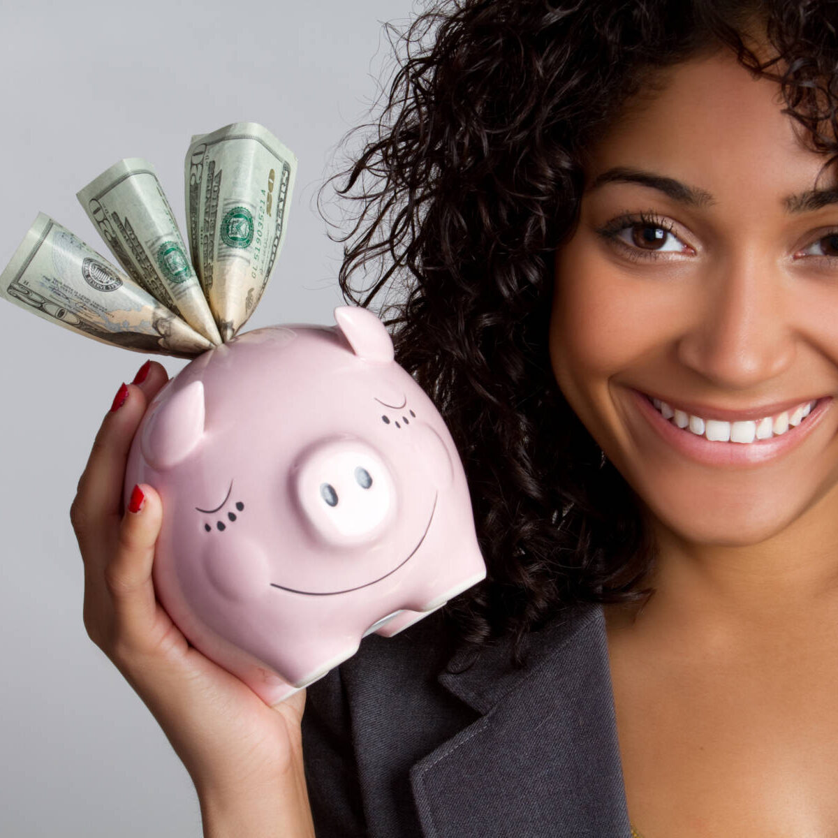 African american woman holding piggy bank
